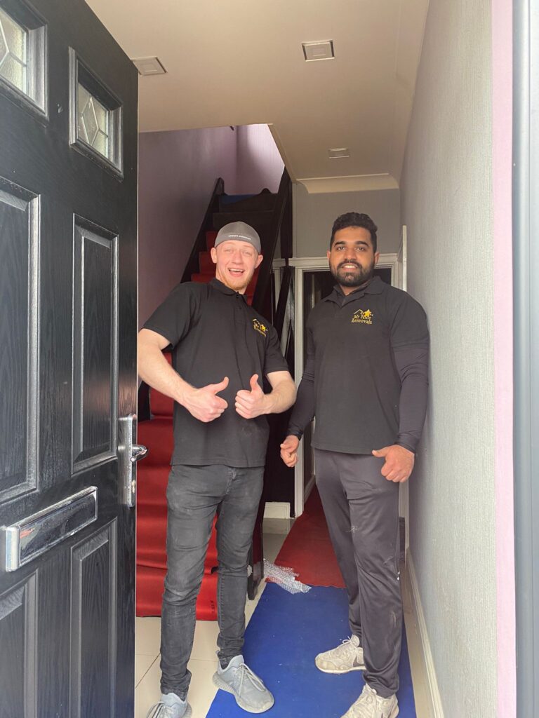 Two men standing in front of a door.